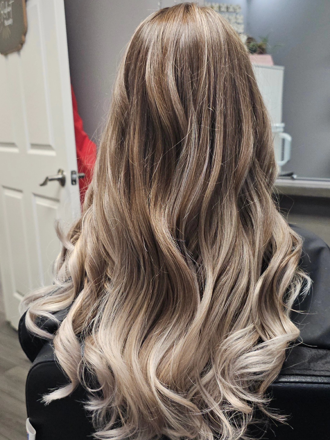 Cool ash blonde balayage with bombshell waves.